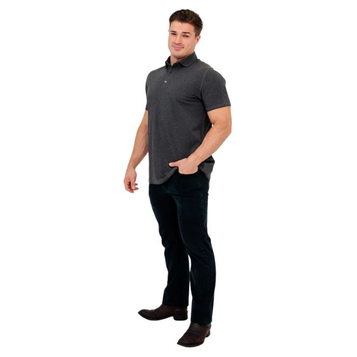 male model wearing graphite grey phil polo shirt and blue jeans side view on white background