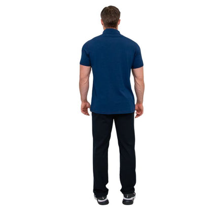 male model wearing indigo blue phil polo shirt and blue jeans back view on white background