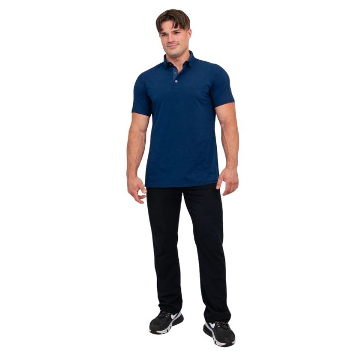 male model wearing indigo blue phil polo shirt and blue jeans front view on white background