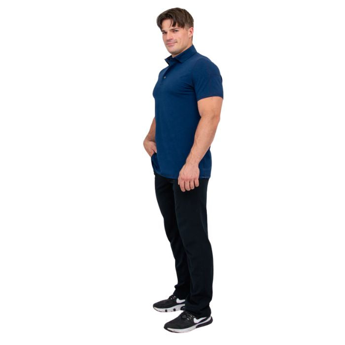male model wearing indigo blue phil polo shirt and blue jeans side view on white background