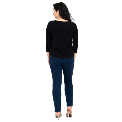 female model wearing black ritzy top and indigo blue nadia pants back view on white background