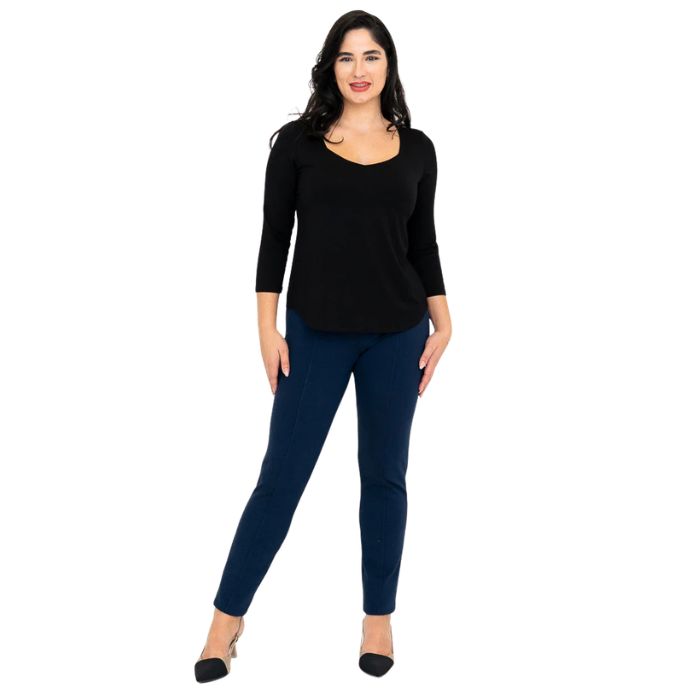 female model wearing black ritzy top and indigo blue nadia pants front view on white background
