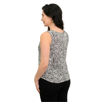 female model wearing black and white rosette print ritzy tank top back view on white background