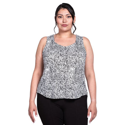 female model wearing black and white rosette print ritzy tank top front view on white background