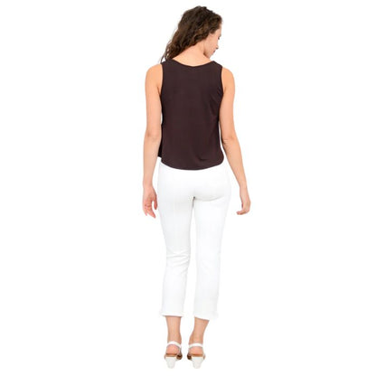 female model wearing coffee brown ritzy tank top and white nadine cropped pants back view on white background