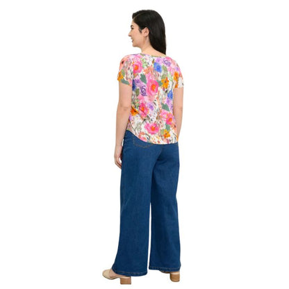 female model wearing pink bouquet print ritzy top and denim blue jeans back view on white background