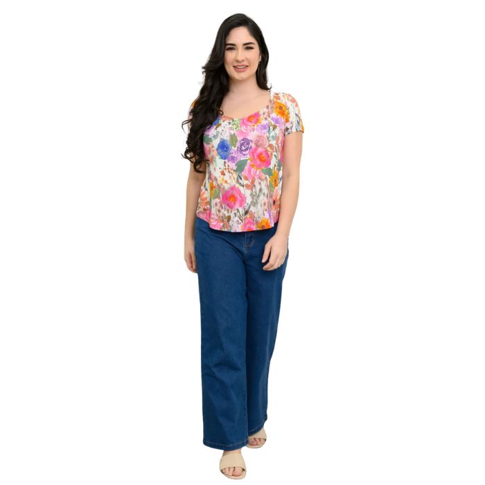 female model wearing pink bouquet print ritzy top and denim blue jeans front view on white background