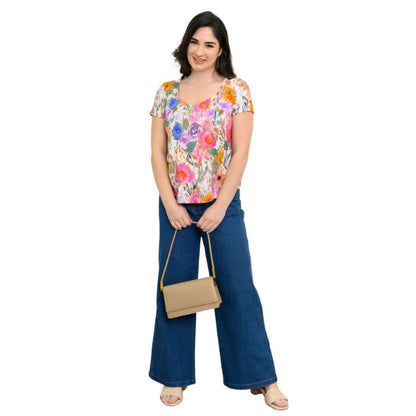 female model wearing pink bouquet print ritzy top and denim blue jeans front view on white background