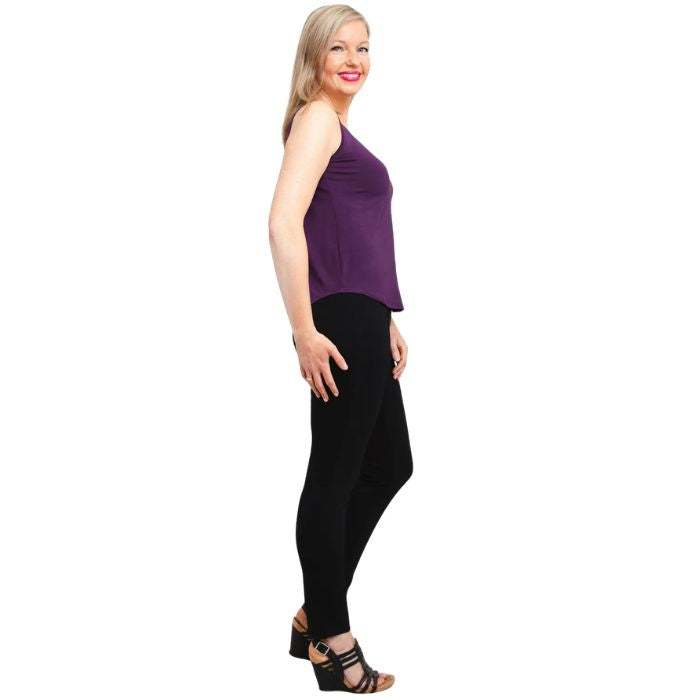 female model wearing royale purple  ritzy tank top and black nadia pants side view on white background