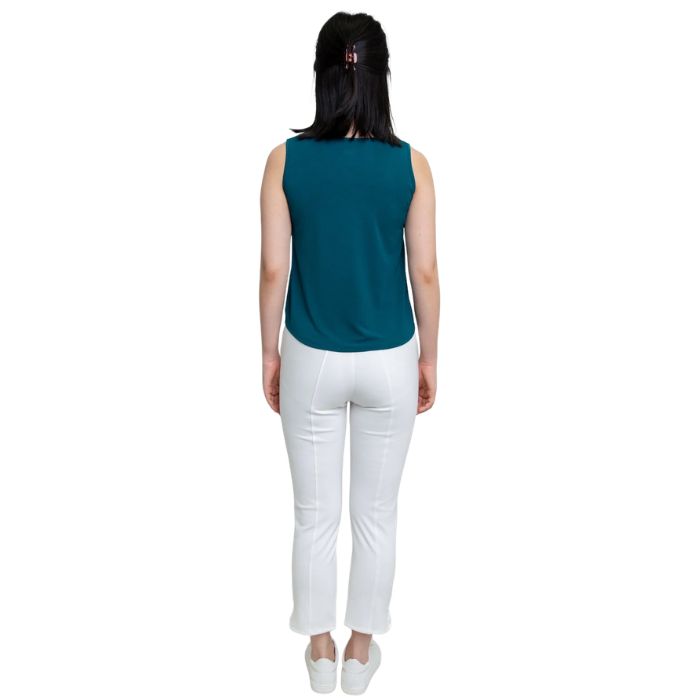 female model wearing teal green ritzy tank top and white nadine cropped pants back view on white background