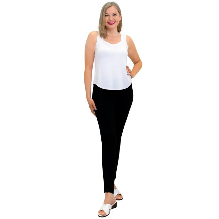 female model wearing white ritzy tank top and black nadia pants front view on white background