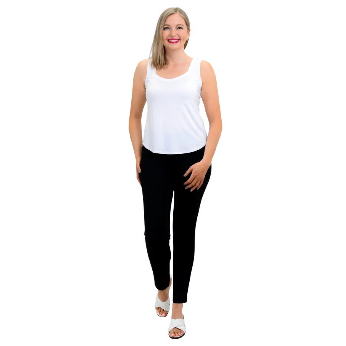 female model wearing white ritzy tank top and black nadia pants front view on white background