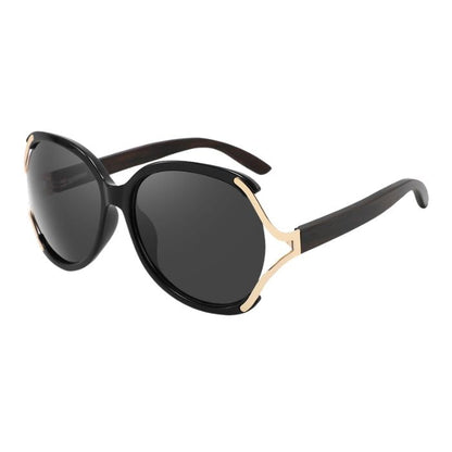 rosewood sunglasses black and gold frames and black lenses over view on white background