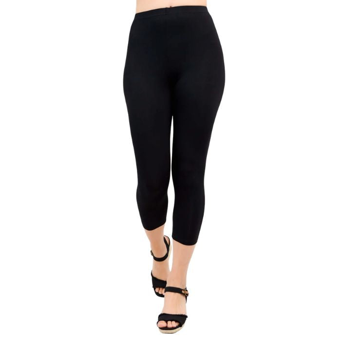 female model wearing black ruby capri leggings front view on white background
