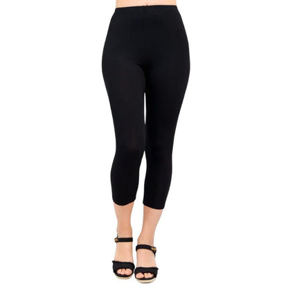 female model wearing black ruby capri leggings front view on white background