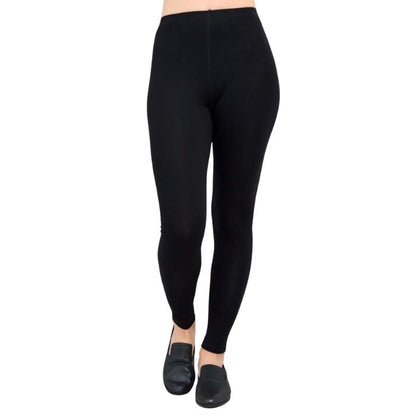 female model wearing black ruby leggings front view on white background