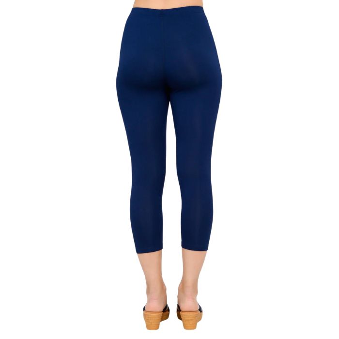 female model wearing indigo blue ruby capri leggings back view on white background