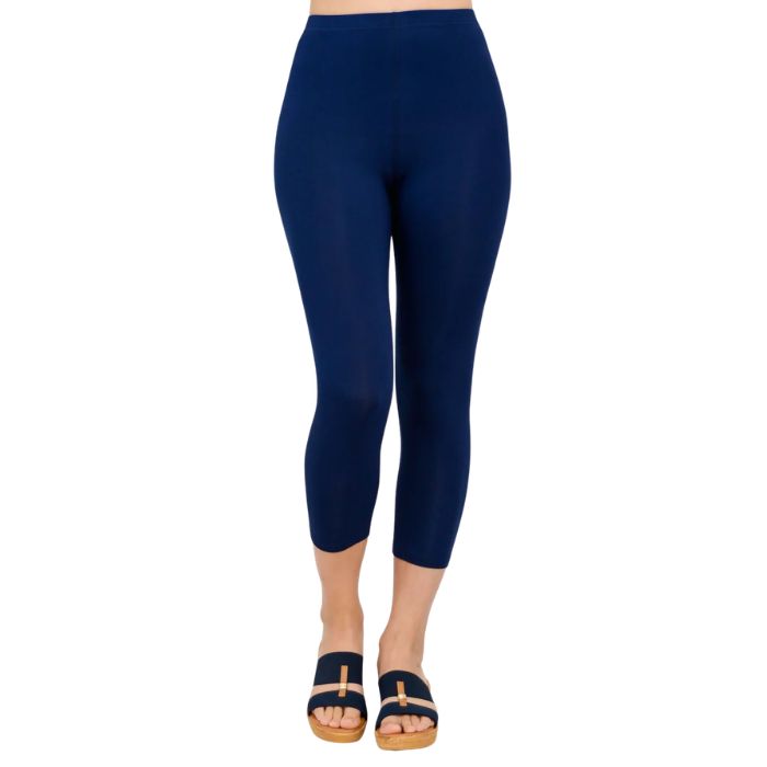 female model wearing indigo blue ruby capri leggings front view on white background