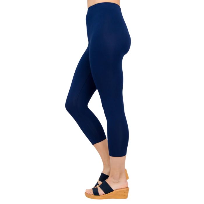 female model wearing indigo blue ruby capri leggings side view on white background