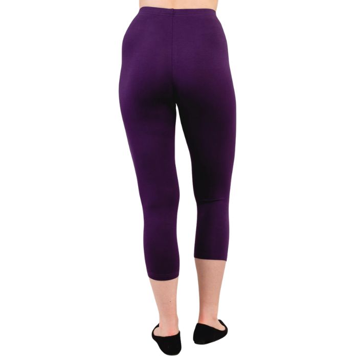 female model wearing royale purple ruby capri leggings back view on white background