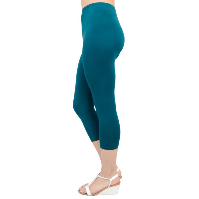 female model wearing teal green ruby capri leggings side view on white background