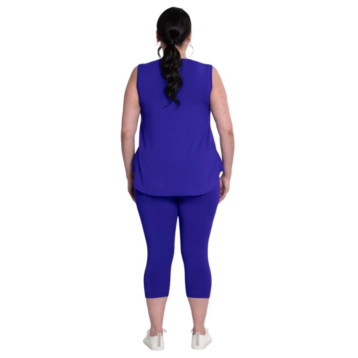 female model wearing violet purple ruby capri leggings and violet purple jazz tank top back view on white background