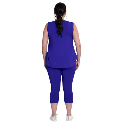 female model wearing violet purple ruby capri leggings and violet purple jazz tank top back view on white background