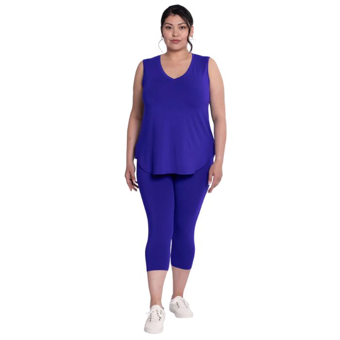 female model wearing violet purple ruby capri leggings and violet purple jazz tank top front view on white background