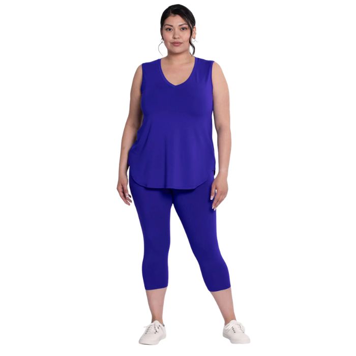 female model wearing violet purple ruby capri leggings and violet purple jazz tank top front view on white background