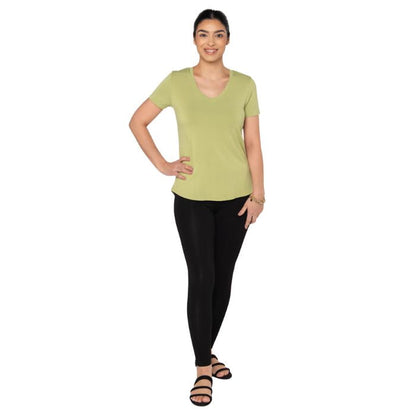 female model wearing citron green rylie v-neck tee and black terry leggings front view on white background