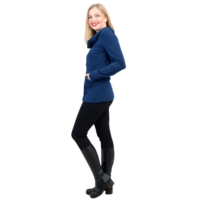 a woman wearing indigo blue seymour jacket and black dixie leggings side view set on a studio white background