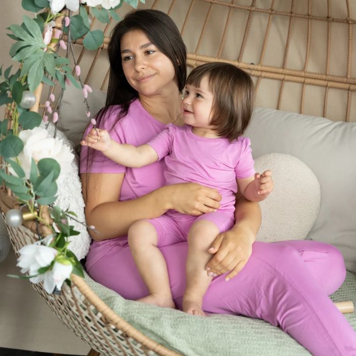 decorative image of woman and girl in matching crocus pink pajama sets.
