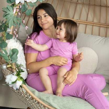 decorative image of woman and girl in matching crocus pink pajama sets.