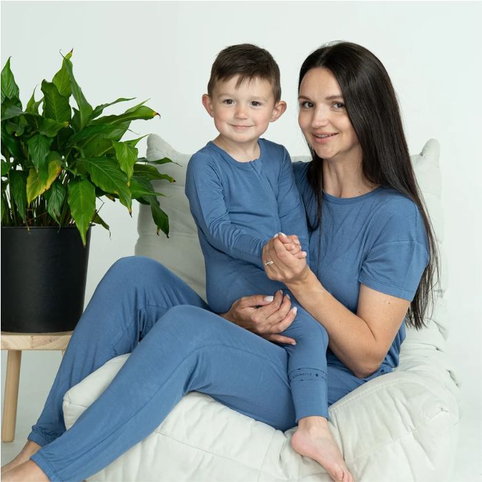 decorative image of woman and boy in matching galactic blue pajama sets.
