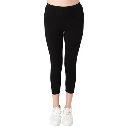 female model wearing black suri capri length leggings front view on white background 
