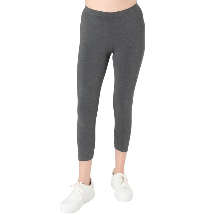female model wearing charcoal grey suri capri length leggings front view on white background 