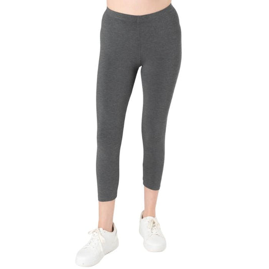 female model wearing charcoal grey suri capri length leggings front view on white background 