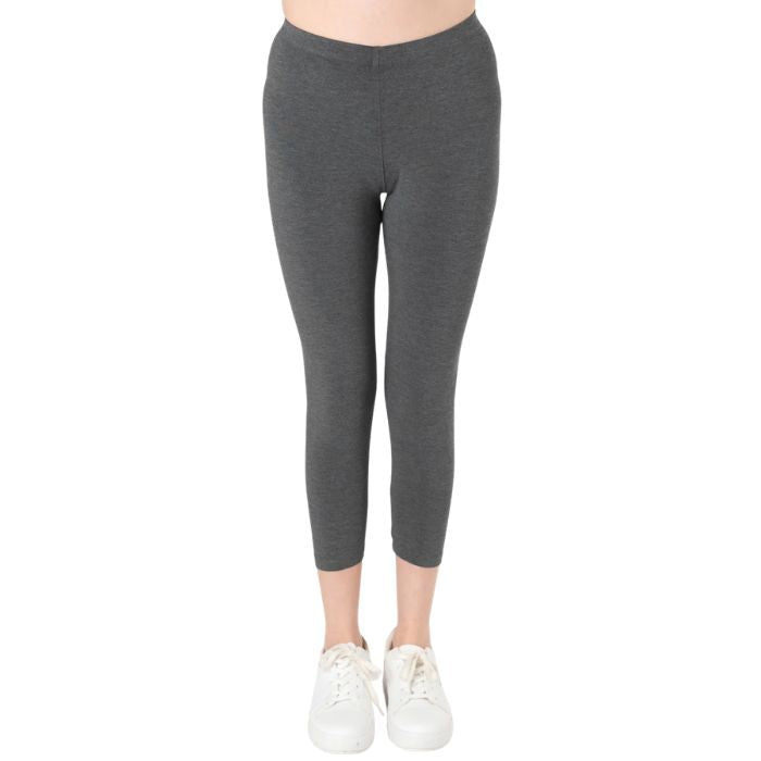female model wearing charcoal grey suri capri length leggings front view on white background 