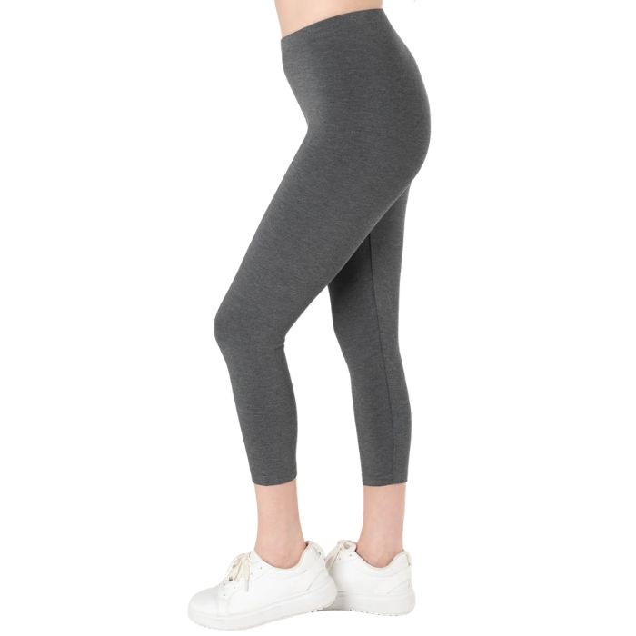 female model wearing charcoal grey suri capri length leggings side view on white background 