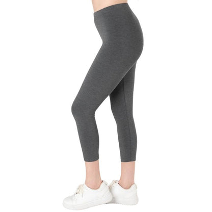 female model wearing charcoal grey suri capri length leggings side view on white background 