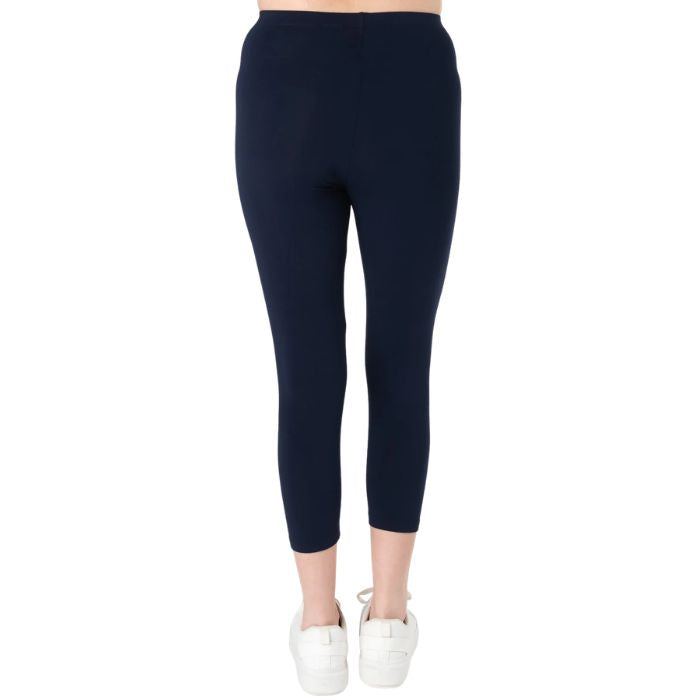 female model wearing ink blue suri capri length leggings back view on white background 