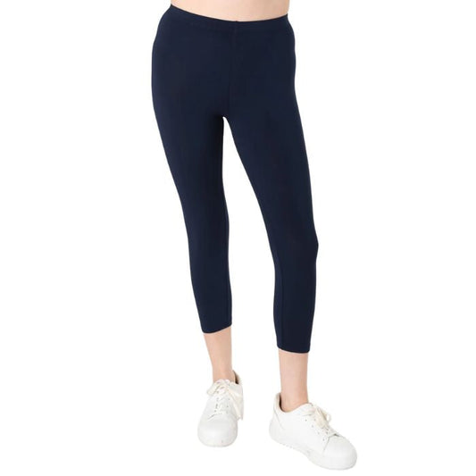 female model wearing ink blue suri capri length leggings front view on white background 