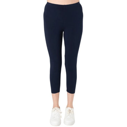 female model wearing ink blue suri capri length leggings front view on white background 