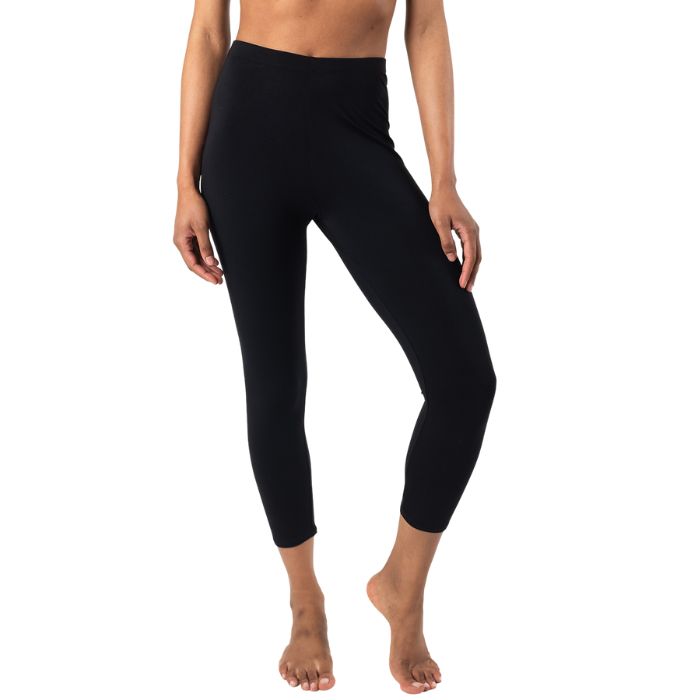 bottom of female model wearing black suri capri length leggings front view on white background 