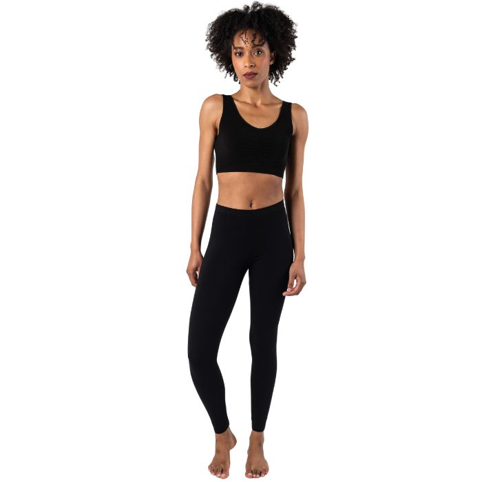 female model wearing black suri full length leggings and black terrera essential bralette front view on white background 