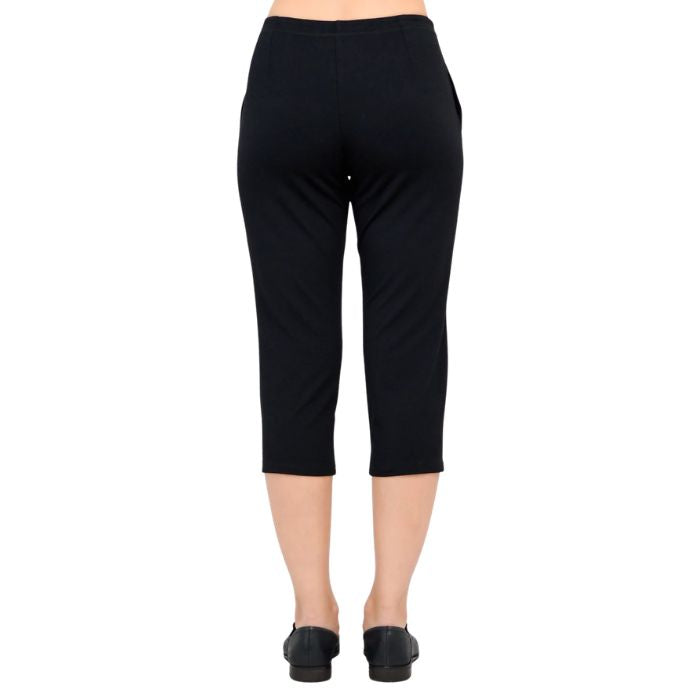 female model wearing black susan capri pants back view on white background