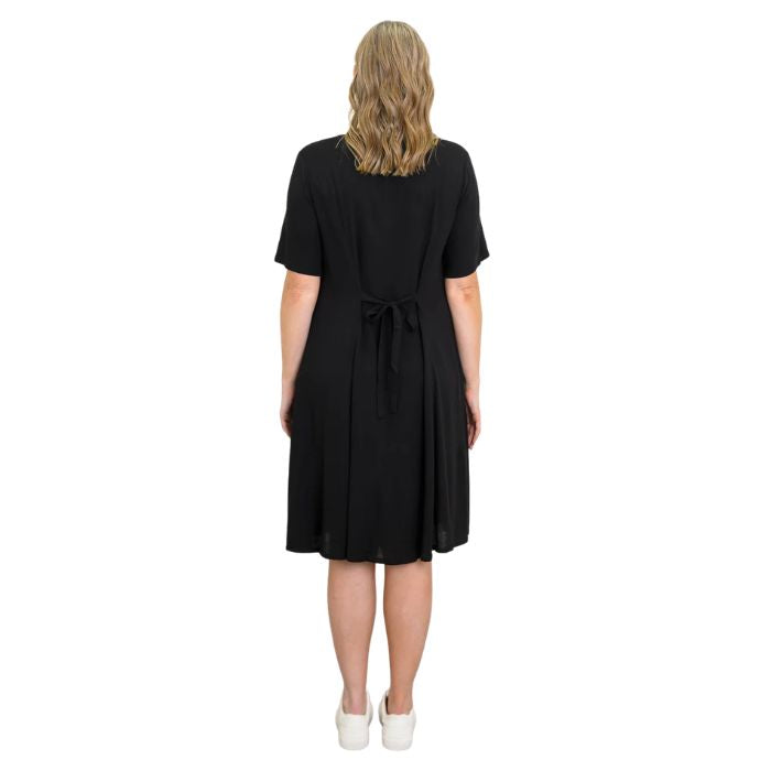 female model wearing black teresa dress back view on white background