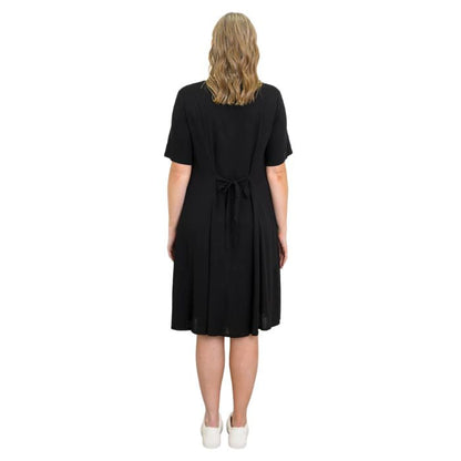 female model wearing black teresa dress back view on white background