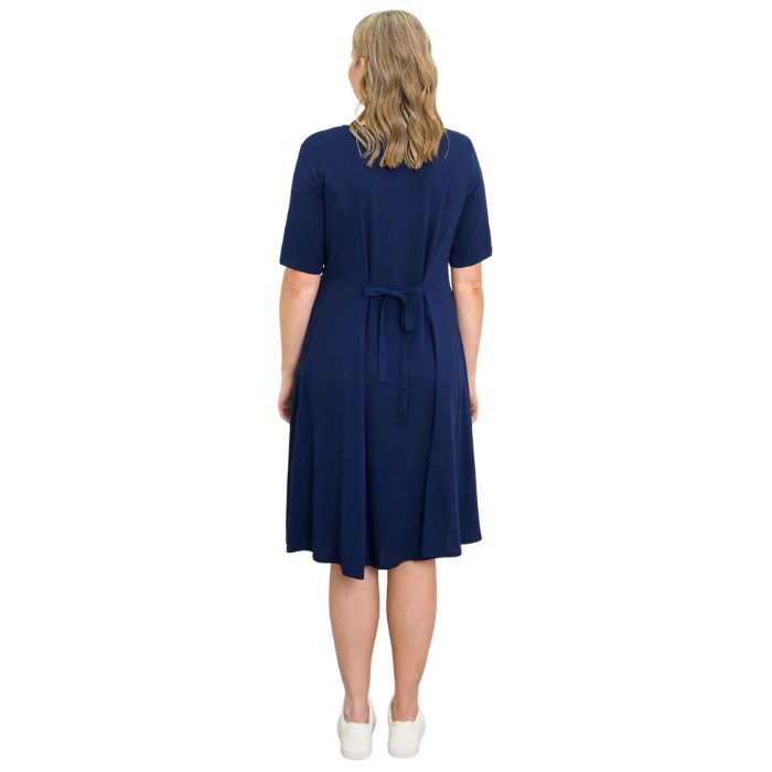 female model wearing indigo blue teresa dress back view on white background