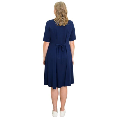 female model wearing indigo blue teresa dress back view on white background